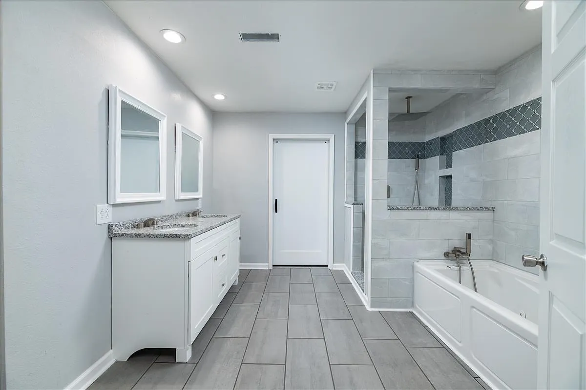 Full master bath remodel with double granite vanity, garden tub, and walk-in arabesque-accented tile shower